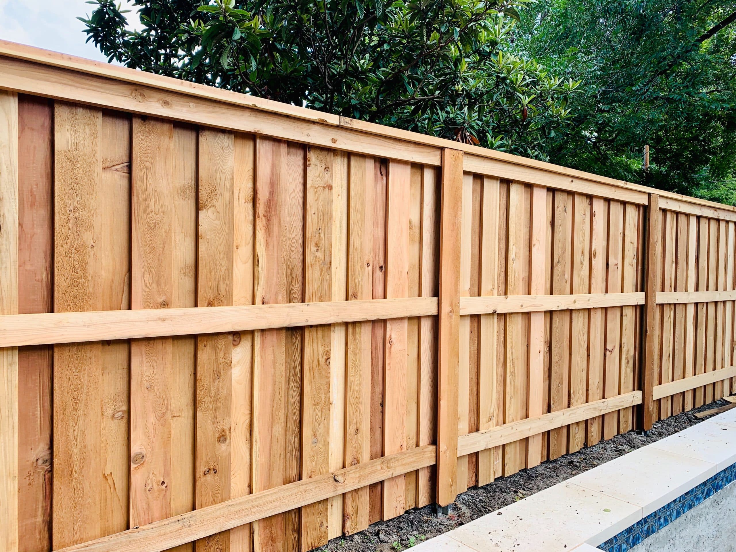 Natural wood privacy fence along a residential backyard