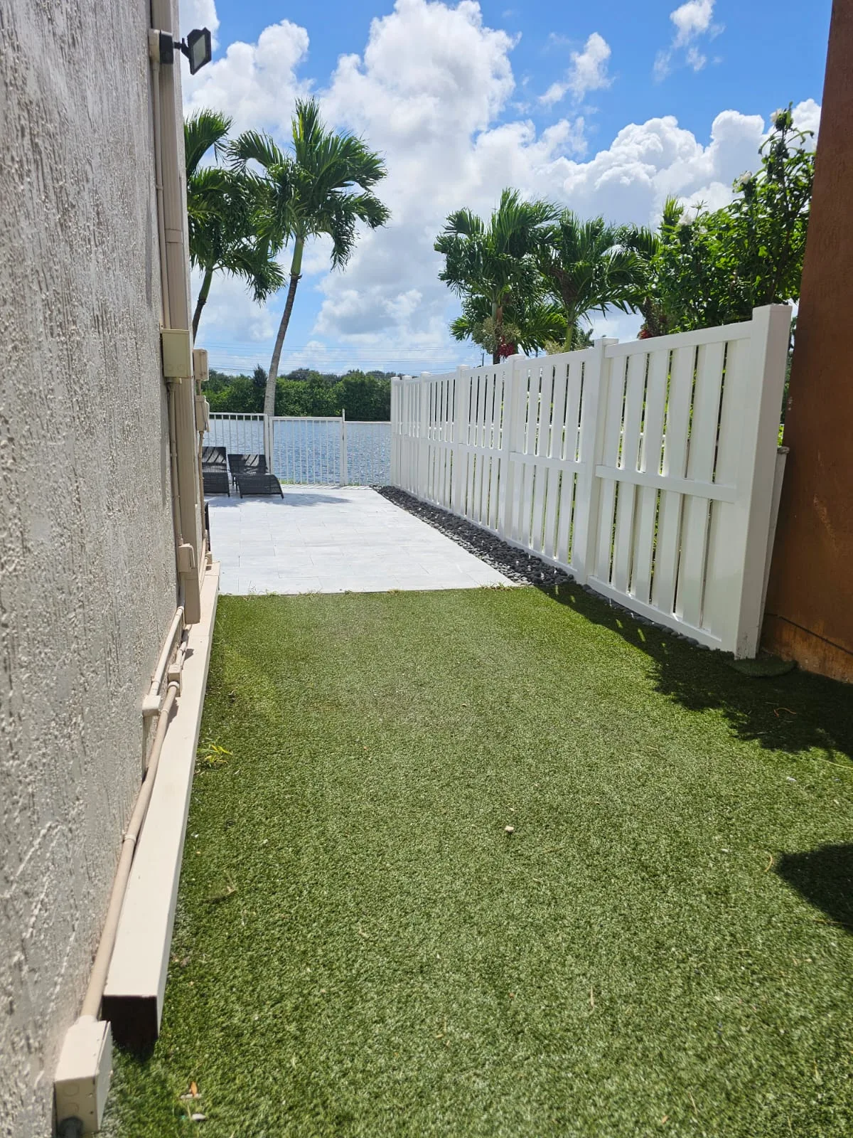 Finished white gate and fence at the property entrance